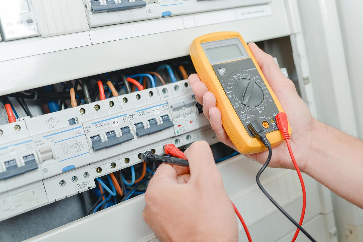 Electrician testing a consumer unit and fuse board